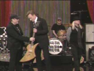 here is a pic of Rick Nielsen giving Conan Obrien a Korina Impulse on 