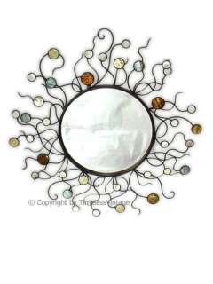   this wrought iron sunburst mirror with is mother of pearl solar flares