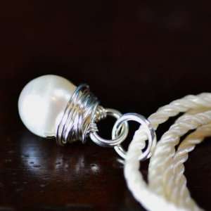 Sea Stone Pendant   white pearl wire wrapped in silver with ivory cord