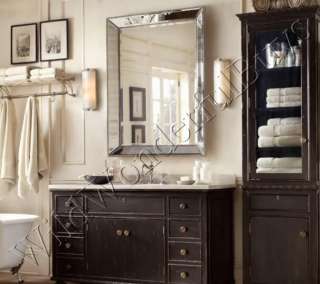 Beveled mirror is embellished with a beaded frame in an antiqued 