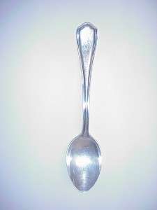spoon is hallmarked with three cursive letters there are no handling 